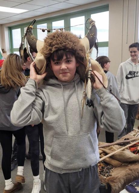 Seventh-grader Shane Lekovitch tries on an animal skin headdress during his study hall