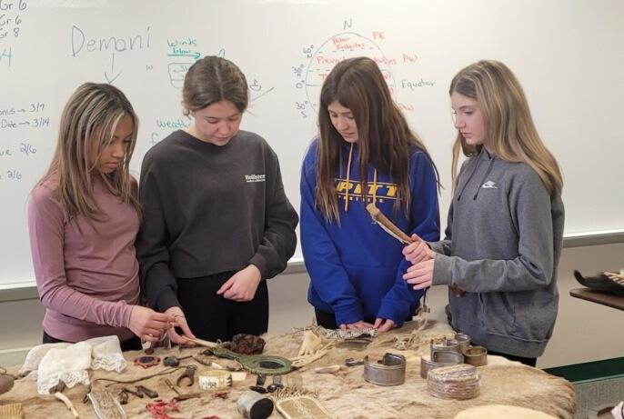 Seventh-graders Morgan Hunter, Mia Mastro, Gianna Armao, and Caroline Lhota examine the artifacts during their study hall period