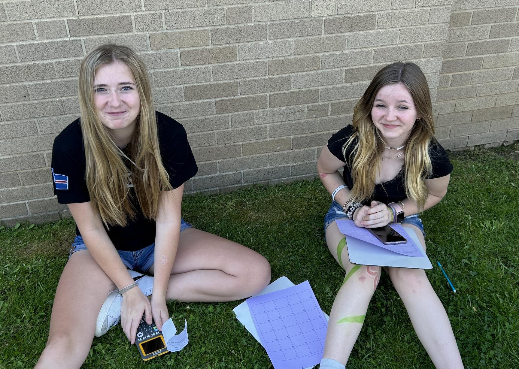 McKenzie Creehan and Emily Hutchison pull out their calculators for a math question