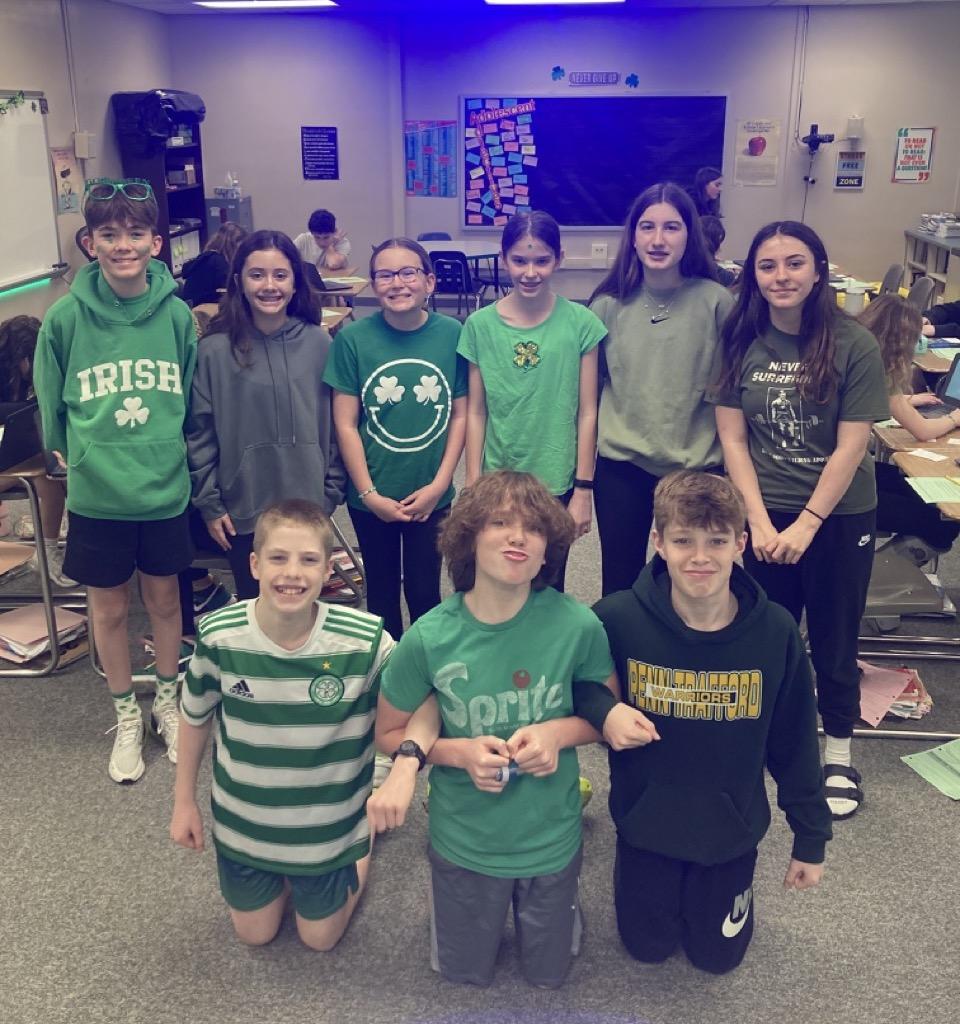 Students take a break from the escape room activity to proudly display their St. Patrick’s Day spirit; (front) Kelton O’Reilly, Finley Malloy, Michael  Madigan, (back) Declan Waddell, Elena Southern, Riley Conley, Ella Southern, Clare Wilson, and Hailey Sadvary